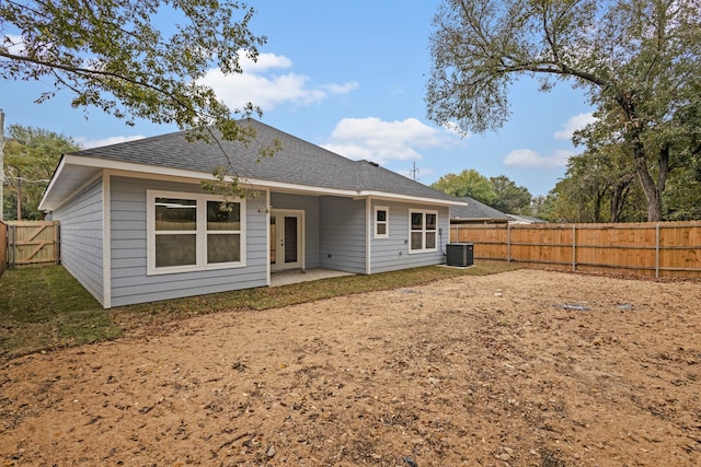 rear view of house with central air condition unit and a patio