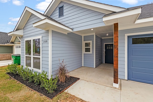 view of exterior entry with a garage