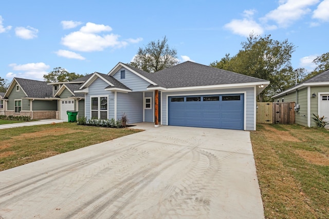 view of front of home with a garage and a front yard