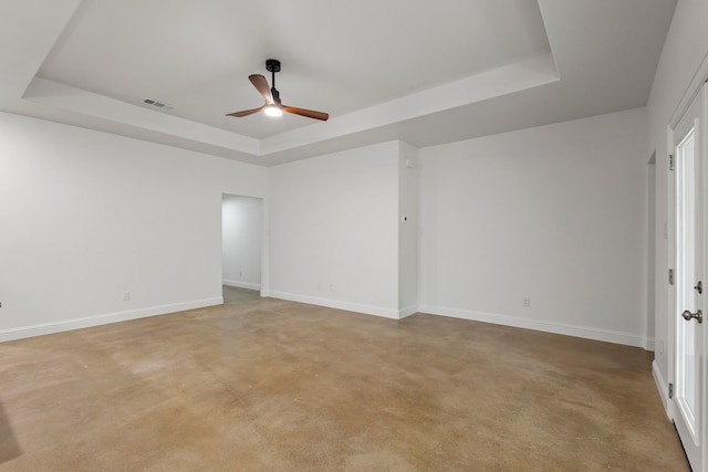 unfurnished room with light carpet, ceiling fan, and a raised ceiling