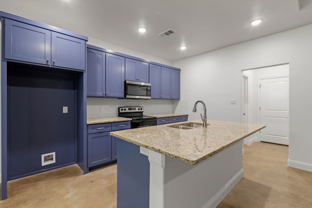 kitchen featuring blue cabinetry, appliances with stainless steel finishes, light stone countertops, sink, and an island with sink