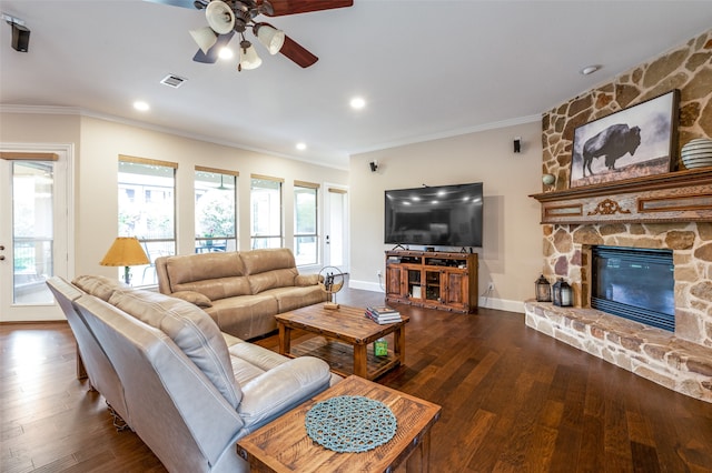 living room with a fireplace, dark hardwood / wood-style flooring, and crown molding