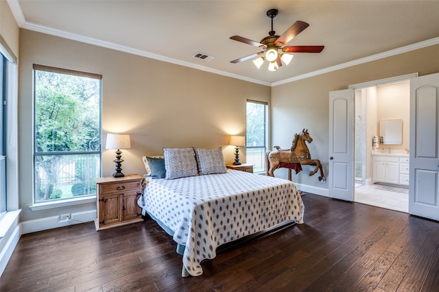 bedroom with multiple windows, dark hardwood / wood-style flooring, ceiling fan, and ensuite bath