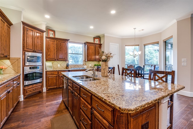 kitchen featuring stainless steel appliances, dark wood-type flooring, and a center island with sink