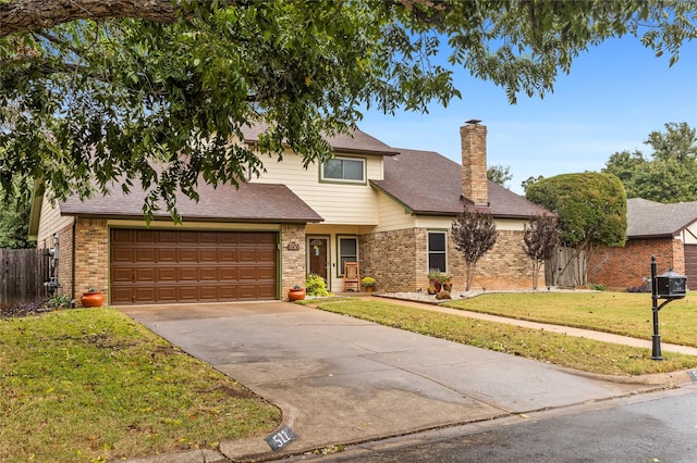 view of front property with a garage and a front yard