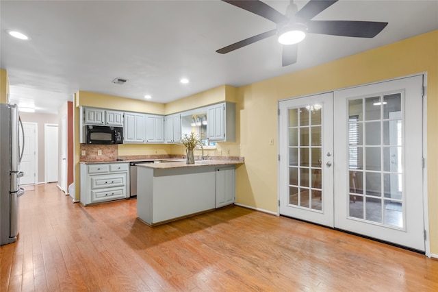 kitchen with french doors, appliances with stainless steel finishes, light hardwood / wood-style floors, and kitchen peninsula