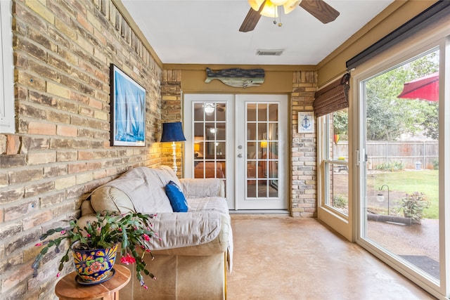 sunroom featuring ceiling fan and french doors