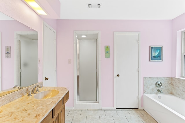 bathroom featuring vanity, tile patterned floors, and separate shower and tub