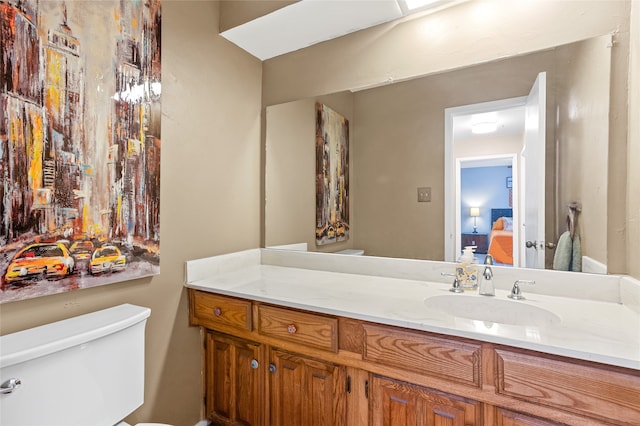 bathroom with vanity and toilet