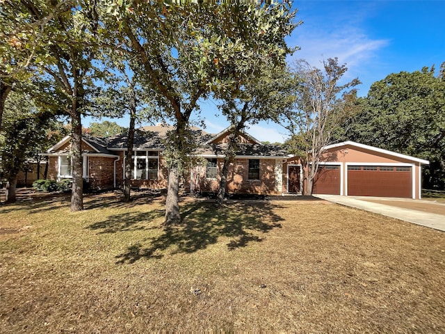 single story home featuring a garage and a front lawn