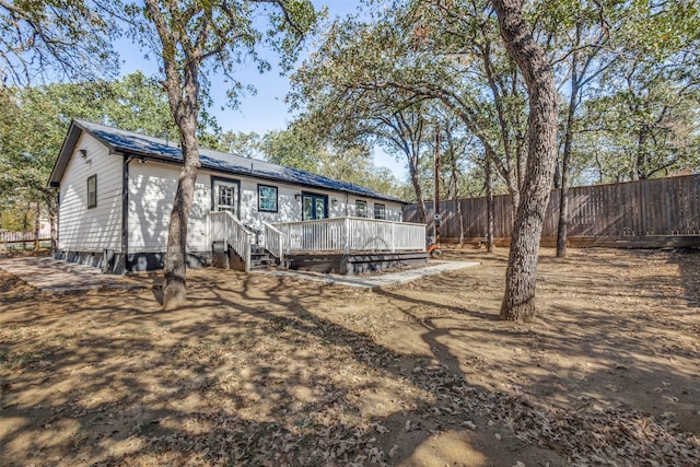 rear view of house with a wooden deck