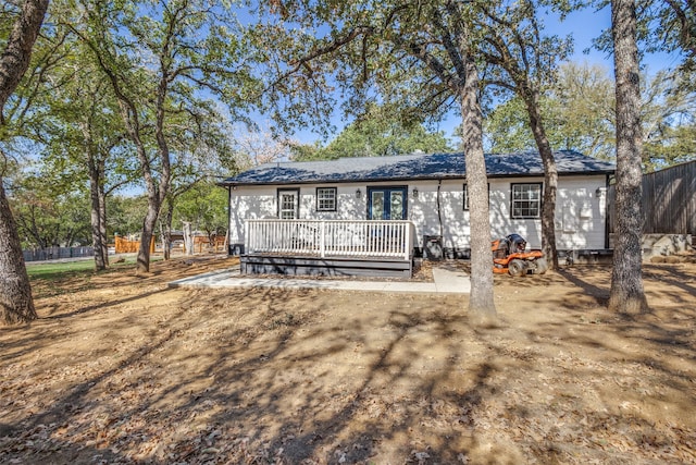 back of house featuring a wooden deck