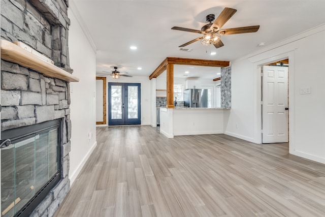 unfurnished living room featuring ceiling fan, light hardwood / wood-style flooring, french doors, and ornamental molding