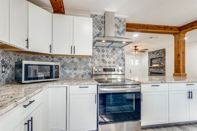 kitchen featuring white cabinets, light hardwood / wood-style flooring, appliances with stainless steel finishes, and exhaust hood