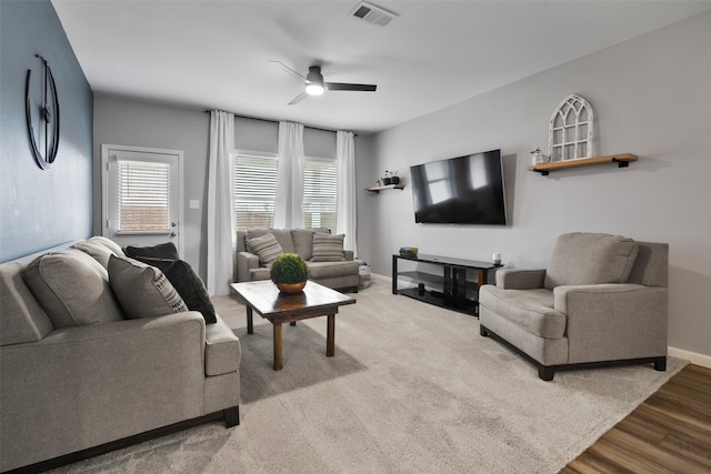 living room featuring ceiling fan and wood-type flooring