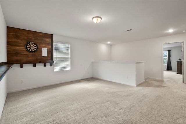 unfurnished room with light carpet