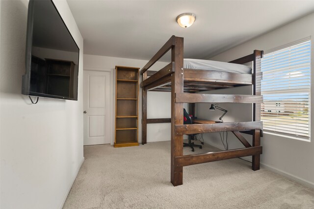 bedroom featuring light carpet