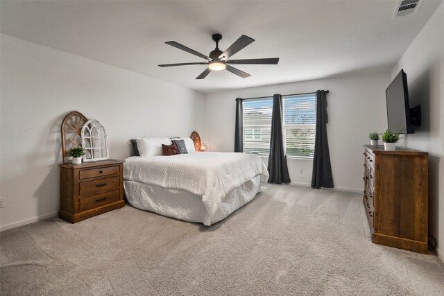 bedroom featuring light colored carpet and ceiling fan