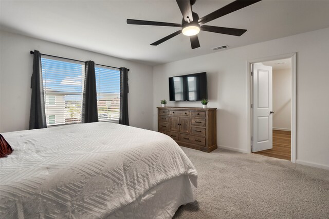 bedroom featuring light carpet and ceiling fan