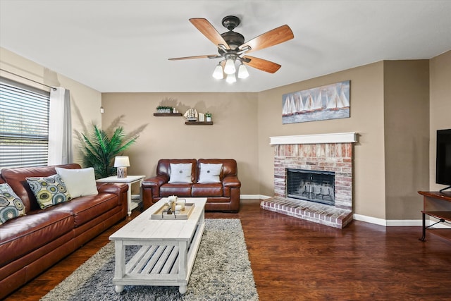 living room with dark hardwood / wood-style floors, a brick fireplace, and ceiling fan