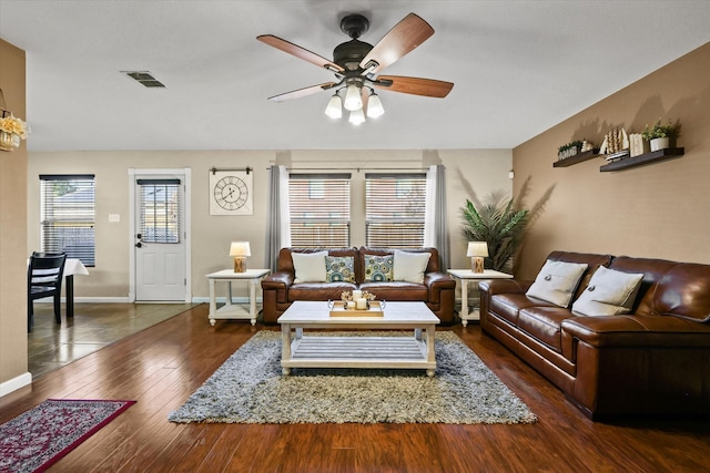 living room with ceiling fan and dark hardwood / wood-style flooring