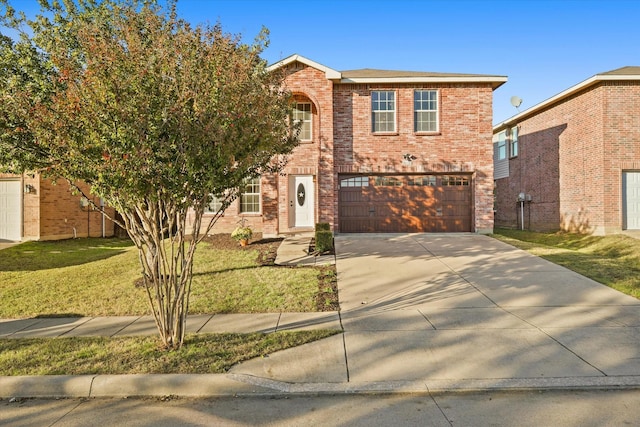 view of front of home with a garage and a front lawn