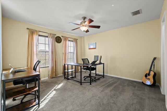 home office with ceiling fan and dark carpet