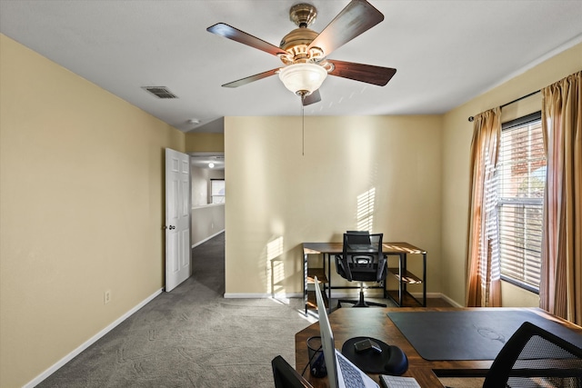 office featuring ceiling fan and dark carpet