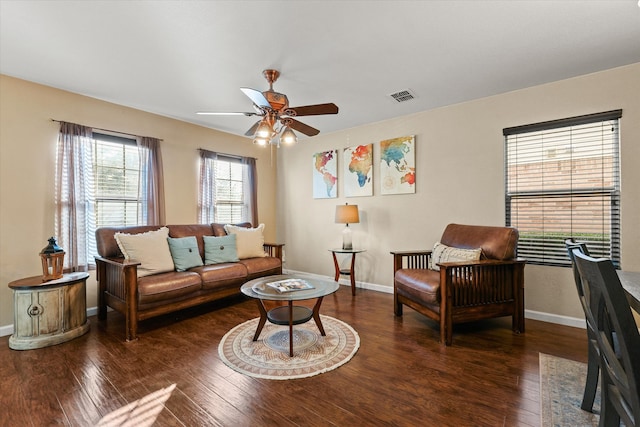 living room featuring dark hardwood / wood-style floors and ceiling fan