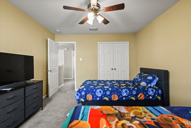 bedroom with light colored carpet, a closet, and ceiling fan