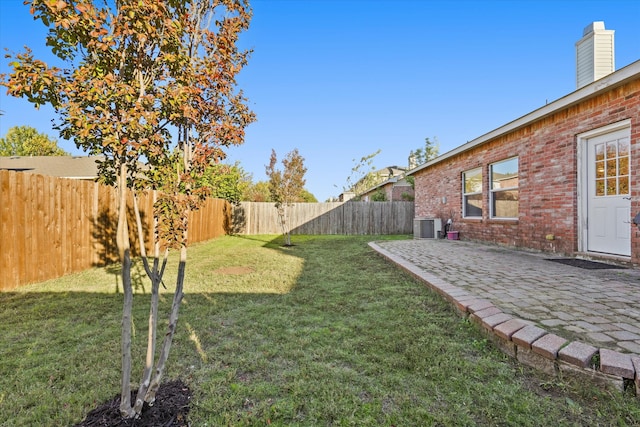 view of yard featuring a patio and central AC unit