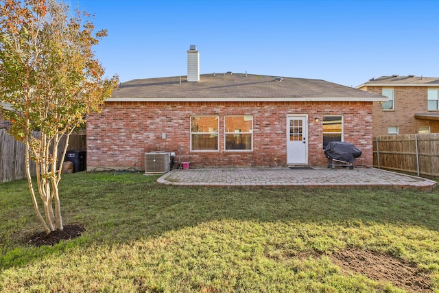 back of house featuring a yard, a patio area, and central air condition unit