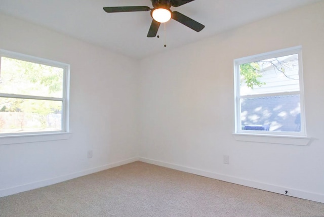 spare room featuring light carpet and ceiling fan