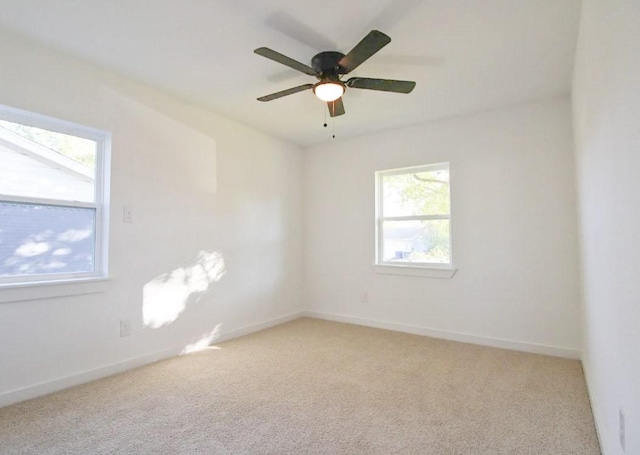 unfurnished room with light colored carpet and ceiling fan