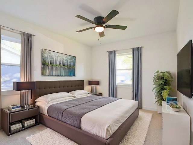 bedroom with ceiling fan and light colored carpet