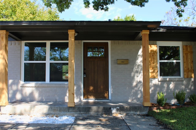 view of exterior entry with covered porch