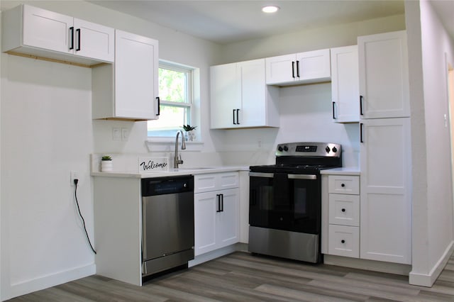 kitchen with white cabinets, dark hardwood / wood-style floors, sink, and stainless steel appliances