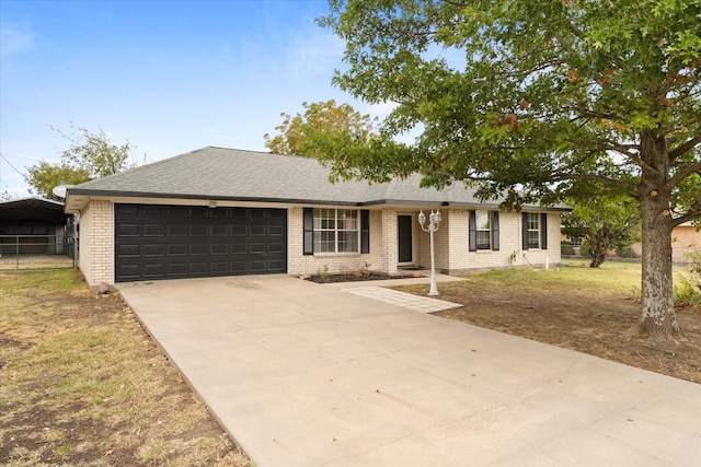 ranch-style home featuring a front lawn and a garage