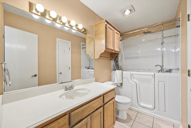 full bathroom featuring tile patterned floors, vanity, a textured ceiling, toilet, and washtub / shower combination