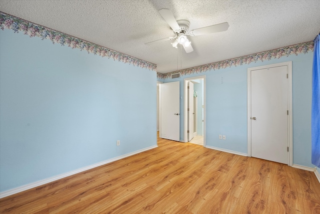 unfurnished bedroom with a textured ceiling, light wood-type flooring, and ceiling fan