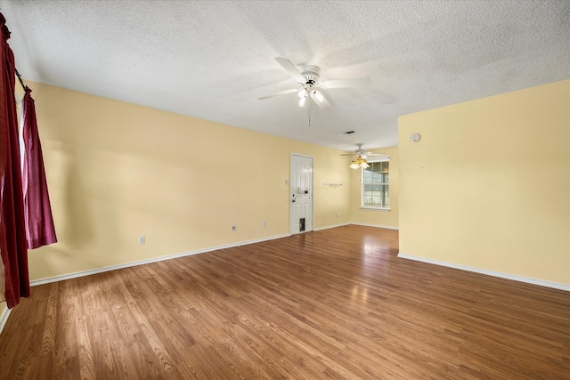 empty room featuring ceiling fan, wood-type flooring, and a textured ceiling