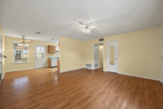 unfurnished living room featuring light wood-type flooring, a textured ceiling, and ceiling fan