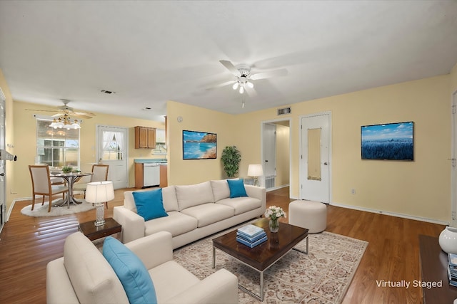 living room featuring light wood-type flooring and ceiling fan