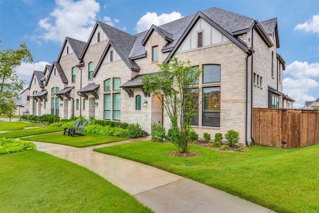 english style home featuring a front yard