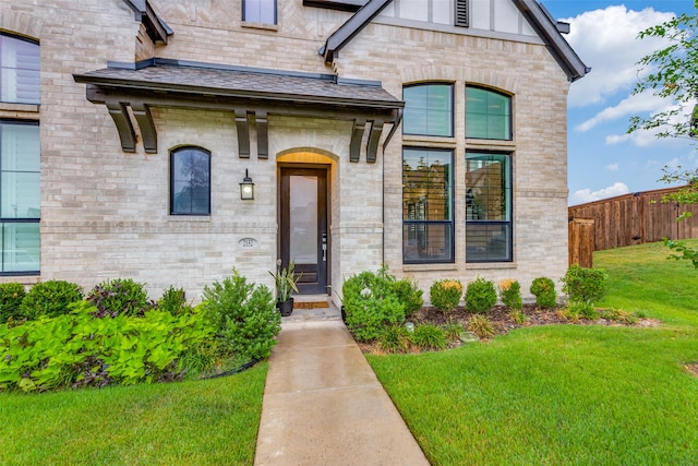 entrance to property featuring a yard