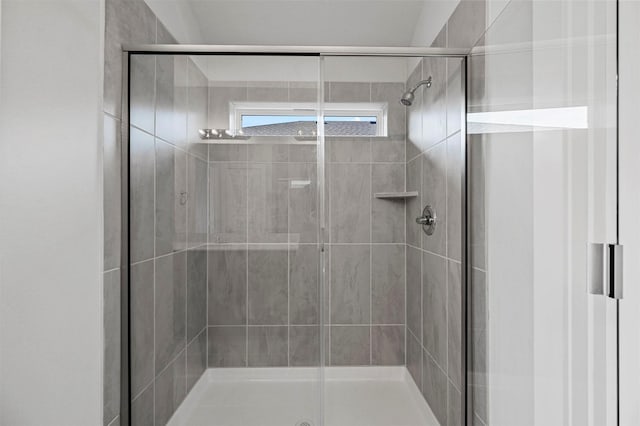 bathroom featuring a shower with door