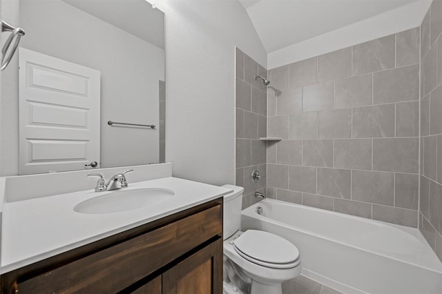 full bathroom featuring tiled shower / bath combo, vanity, lofted ceiling, and toilet