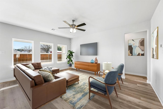 living room featuring ceiling fan and light wood-type flooring