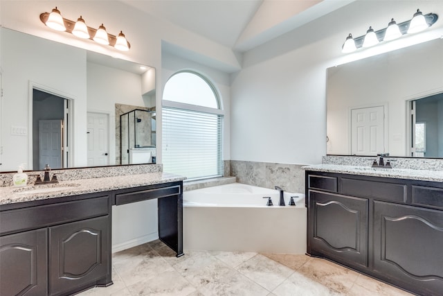 bathroom with vanity, separate shower and tub, and high vaulted ceiling