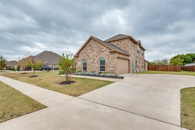 view of front of property with a garage and a front lawn